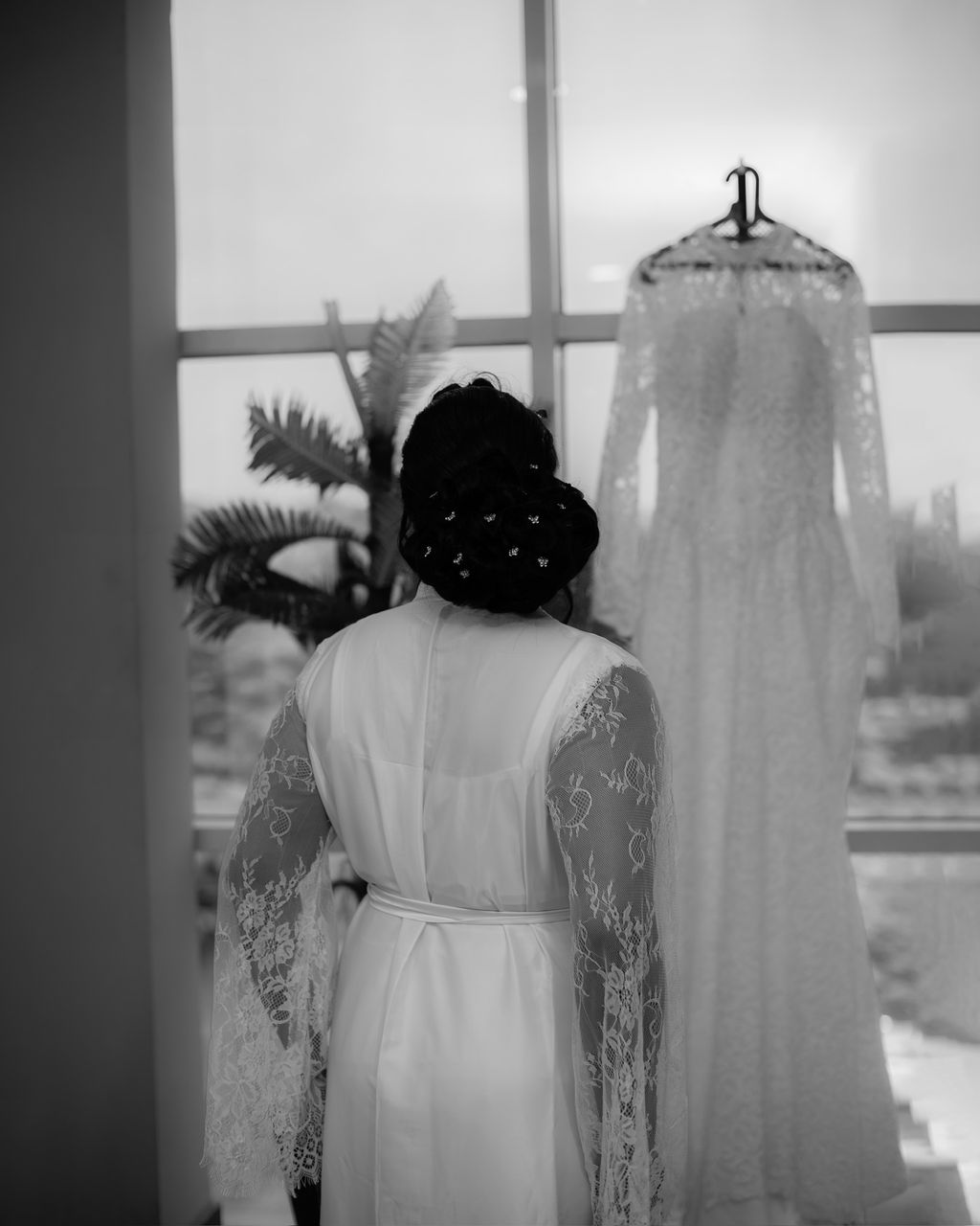 Fitted ivory lace wedding gown with long sleeves.